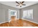 Bedroom featuring hardwood floors, a ceiling fan, and double doors leading to another room at 3634 Lost Oak Dr, Buford, GA 30519