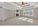 Bright bedroom with tray ceiling, fan, fireplace and natural light from multiple windows at 3634 Lost Oak Dr, Buford, GA 30519