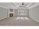 Spacious bedroom featuring a fireplace, carpeted flooring, and a trey ceiling with modern ceiling fan at 3634 Lost Oak Dr, Buford, GA 30519