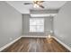 Bedroom featuring new wood-look flooring, fresh gray paint, and updated ceiling fan at 3634 Lost Oak Dr, Buford, GA 30519
