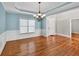 Elegant dining room featuring hardwood floors, blue walls, and abundant natural light at 3634 Lost Oak Dr, Buford, GA 30519