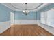 Elegant dining room with hardwood floors, wainscoting, and a chandelier at 3634 Lost Oak Dr, Buford, GA 30519