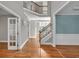 Grand foyer with gleaming hardwood floors, high ceilings, and staircase leading to the second floor at 3634 Lost Oak Dr, Buford, GA 30519
