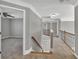 Upstairs hallway with gray walls and carpet that connects to a bonus room at 3634 Lost Oak Dr, Buford, GA 30519