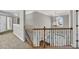 Upstairs hallway with wooden railing, chandelier, and a view of the staircase at 3634 Lost Oak Dr, Buford, GA 30519