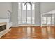 Bright living room featuring hardwood floors, a fireplace, and large windows offering plenty of light at 3634 Lost Oak Dr, Buford, GA 30519