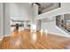 Open concept living area featuring hardwood floors, tall ceilings and open access to the kitchen area at 3634 Lost Oak Dr, Buford, GA 30519