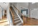 Grand staircase welcomes you with wood and iron railings, leading to the upper levels of the home at 3634 Lost Oak Dr, Buford, GA 30519