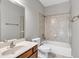 Neutral bathroom with a tile-surround tub and shower, toilet, and single sink vanity at 3634 Lost Oak Drive, Buford, GA 30519