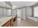 Bathroom featuring a double vanity, a soaking tub, and a tiled floor at 3634 Lost Oak Drive, Buford, GA 30519