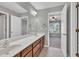 Bright bathroom features a double sink vanity, large mirror and a doorway to the main bedroom at 3634 Lost Oak Drive, Buford, GA 30519