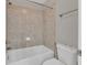 Bathroom with tiled shower over tub and white toilet, complemented by neutral wall color at 3634 Lost Oak Drive, Buford, GA 30519