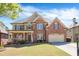 Charming two-story brick home with a well-manicured lawn and inviting front porch at 3634 Lost Oak Drive, Buford, GA 30519