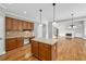 Bright and airy kitchen featuring hardwood floors, granite countertops, an island, and stainless appliances at 3634 Lost Oak Drive, Buford, GA 30519