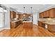 Well-lit kitchen boasts hardwood floors, an island, stainless steel appliances, and ample cabinet space at 3634 Lost Oak Drive, Buford, GA 30519