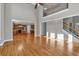 Open living room showcases hardwood floors, a staircase, and a view into the kitchen at 3634 Lost Oak Drive, Buford, GA 30519