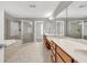 Spacious main bathroom with double sink vanity, tiled flooring, glass enclosed shower, and separate tub at 3634 Lost Oak Drive, Buford, GA 30519