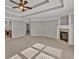 Spacious main bedroom featuring a trey ceiling, carpet flooring, and a fireplace with white mantle at 3634 Lost Oak Drive, Buford, GA 30519