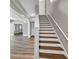 Staircase with stained wood treads and painted risers leads to the upper level of the home at 3634 Lost Oak Drive, Buford, GA 30519