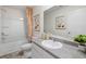 Well-lit bathroom with vanity, tub, and shower showcasing modern fixtures and neutral tones at 4277 Arcadia Dr, Decatur, GA 30034