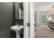 Neat powder room with pedestal sink and doorway that opens up to the view of the living room at 4277 Arcadia Dr, Decatur, GA 30034