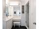 Stylish bathroom with sleek vanity, stool, and glass-enclosed shower at 540 Cambridge Way, Atlanta, GA 30328