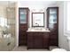 Well-lit bathroom featuring dual storage towers, vanity, and a glass shower at 540 Cambridge Way, Atlanta, GA 30328