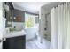 Elegant bathroom showcasing a vanity with marble countertop and a shower with white tile at 540 Cambridge Way, Atlanta, GA 30328