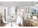 Cozy dining area with white wicker chairs, a table, and seamless access to the kitchen and foyer at 540 Cambridge Way, Atlanta, GA 30328