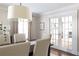 A cozy dining area filled with natural light, featuring French doors and a stylish chandelier at 540 Cambridge Way, Atlanta, GA 30328
