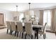 Elegant dining room with a long table, comfortable seating for ten, and soft neutral décor at 540 Cambridge Way, Atlanta, GA 30328