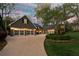 Home featuring a spacious driveway leading to a multi-car garage, and manicured landscaping at 540 Cambridge Way, Atlanta, GA 30328