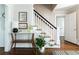 Bright foyer featuring hardwood floors, staircase with white railing, and entry table with decor at 540 Cambridge Way, Atlanta, GA 30328