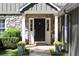 Charming front entry featuring a stone facade, black door, and beautiful planters at 540 Cambridge Way, Atlanta, GA 30328
