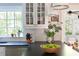Kitchen featuring black countertops, white cabinets, and a large window offering natural light and a view at 540 Cambridge Way, Atlanta, GA 30328