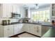 Bright kitchen with stainless steel appliances, subway tile backsplash, and view from large window at 540 Cambridge Way, Atlanta, GA 30328