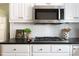 Modern kitchen with stainless steel microwave and gas cooktop set against a white subway tile backsplash at 540 Cambridge Way, Atlanta, GA 30328