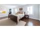 Sunlit bedroom with neutral walls, hardwood floors, and a view into the en suite bathroom at 540 Cambridge Way, Atlanta, GA 30328