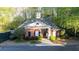 Pool house with brick facade, lush landscaping, and secure gated entrance at 540 Cambridge Way, Atlanta, GA 30328