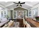 Relaxing sunroom with ample seating, wood table, and garden view at 540 Cambridge Way, Atlanta, GA 30328