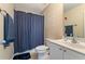 Bathroom features a shower with blue curtain, sink with cabinet, and a towel rack at 150 Fitzroy Ln, Acworth, GA 30101