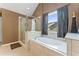Bathroom features a glass shower and soaking tub with a window at 150 Fitzroy Ln, Acworth, GA 30101