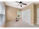 Bedroom with neutral walls, a ceiling fan, a double door closet, and a bright window at 150 Fitzroy Ln, Acworth, GA 30101