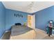 Cozy bedroom with blue walls, carpet, and ceiling fan at 150 Fitzroy Ln, Acworth, GA 30101