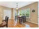Bright breakfast nook features a wood table, black chairs, and a large window with a view of the backyard at 150 Fitzroy Ln, Acworth, GA 30101