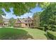 Charming brick home with manicured lawn, mature trees, and tasteful landscaping at 150 Fitzroy Ln, Acworth, GA 30101