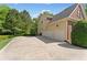 Spacious three-car garage and large driveway next to a home with brick and beige siding at 150 Fitzroy Ln, Acworth, GA 30101