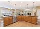 Spacious kitchen island featuring stone countertops, wood cabinetry, and pendant lighting at 150 Fitzroy Ln, Acworth, GA 30101