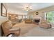Spacious living room with fireplace, plush seating, and open layout to the kitchen, perfect for entertaining at 150 Fitzroy Ln, Acworth, GA 30101