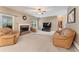 Comfortable living room with a brick fireplace, ceiling fan, and lots of natural light at 150 Fitzroy Ln, Acworth, GA 30101